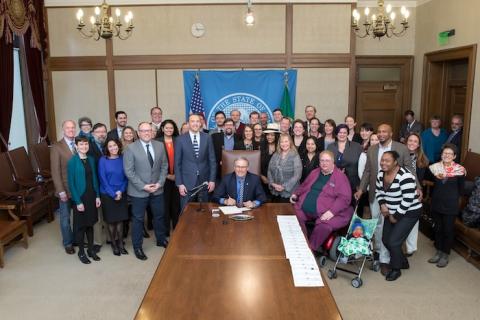 Advocates and lawmakers gathered for a bill signing in Olympia.