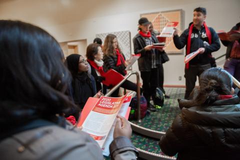 Advocacy Day volunteers standing in a hallway with handouts.